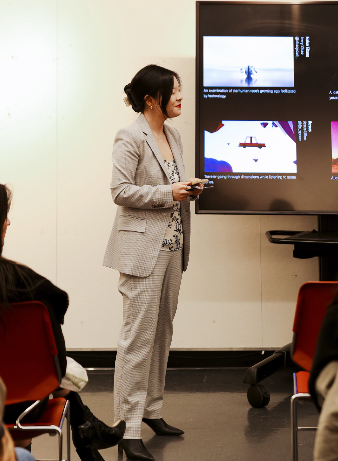 Professor Snow Fu stands near a television screen